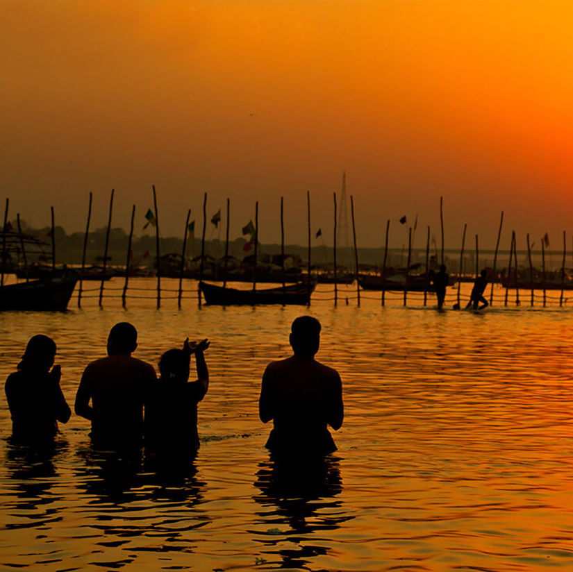 Hotel Polo Max, Allahabad - silhouette of people taking a dip in a river