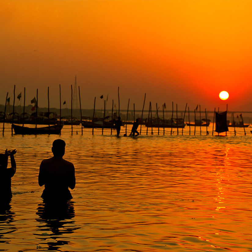 Hotel Polo Max, Allahabad - silhouette of people taking a dip in a river