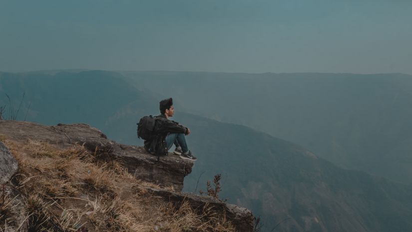 Trekker resting at Laitlum Canyons during monsoon in Shillong