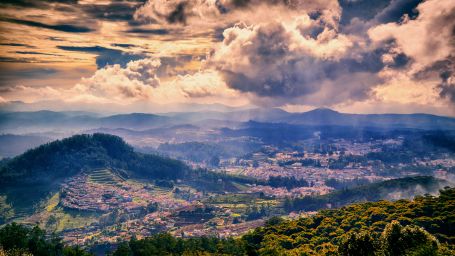 An overview of the city of Ooty viewed aerially with different hues in the sky