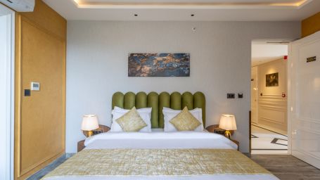 A front view of the bed with a lamp beside it in a bedroom  | Renest Calangute, Goa