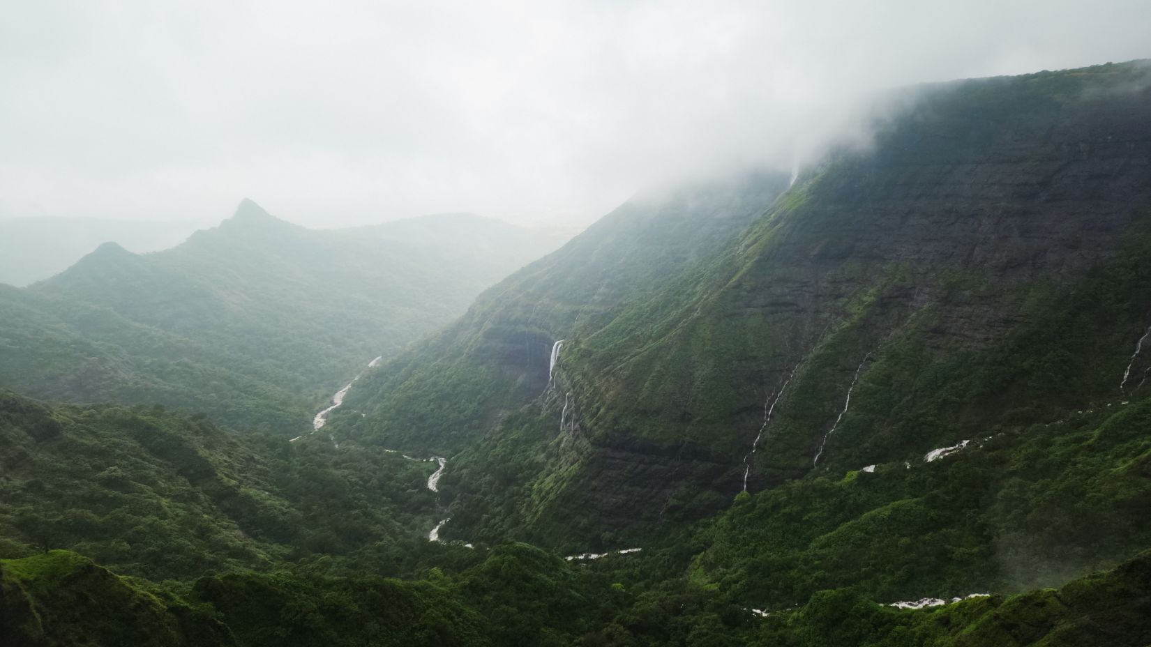 View of valley with waterfall in the middle of it