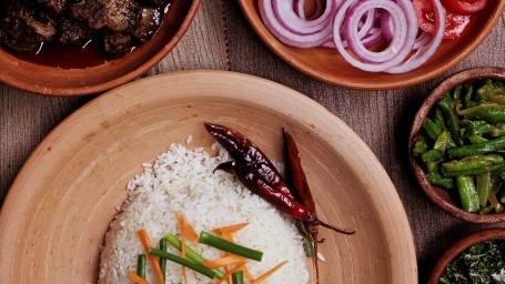 sri lankan meal with a bowl of rice and vegetables