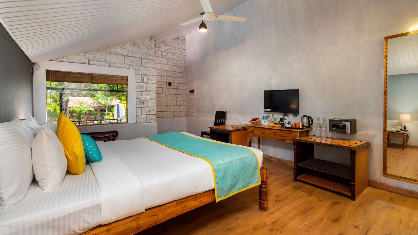 Lotus eco beach resort, king size bed with tv and table in Konkan Villas