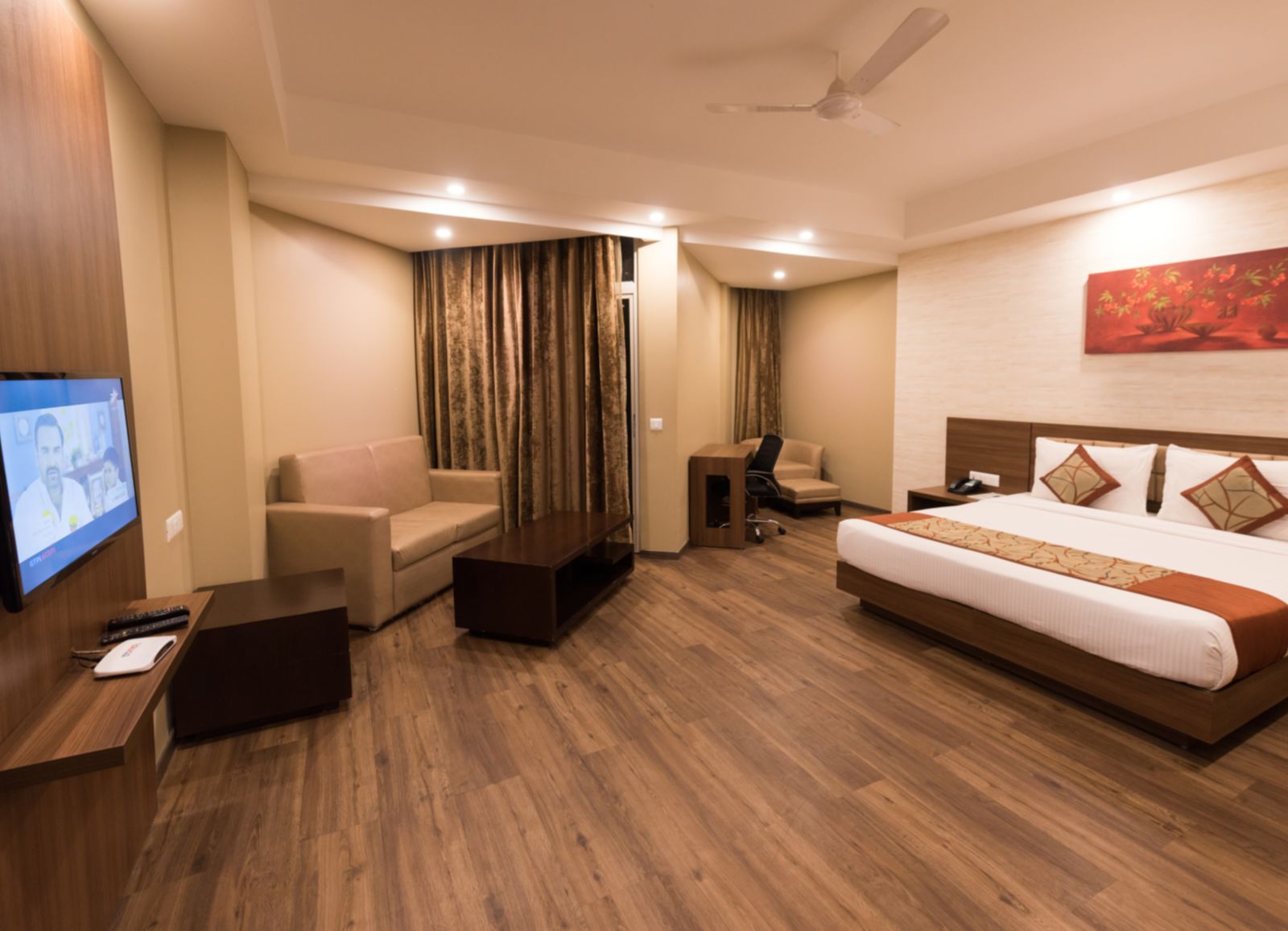 Super Deluxe Rooms with Complimentary Wi-Fi captured with a cosy bed and white linens along with a beige couch - Le ROI Digha Hotel West Bengal2