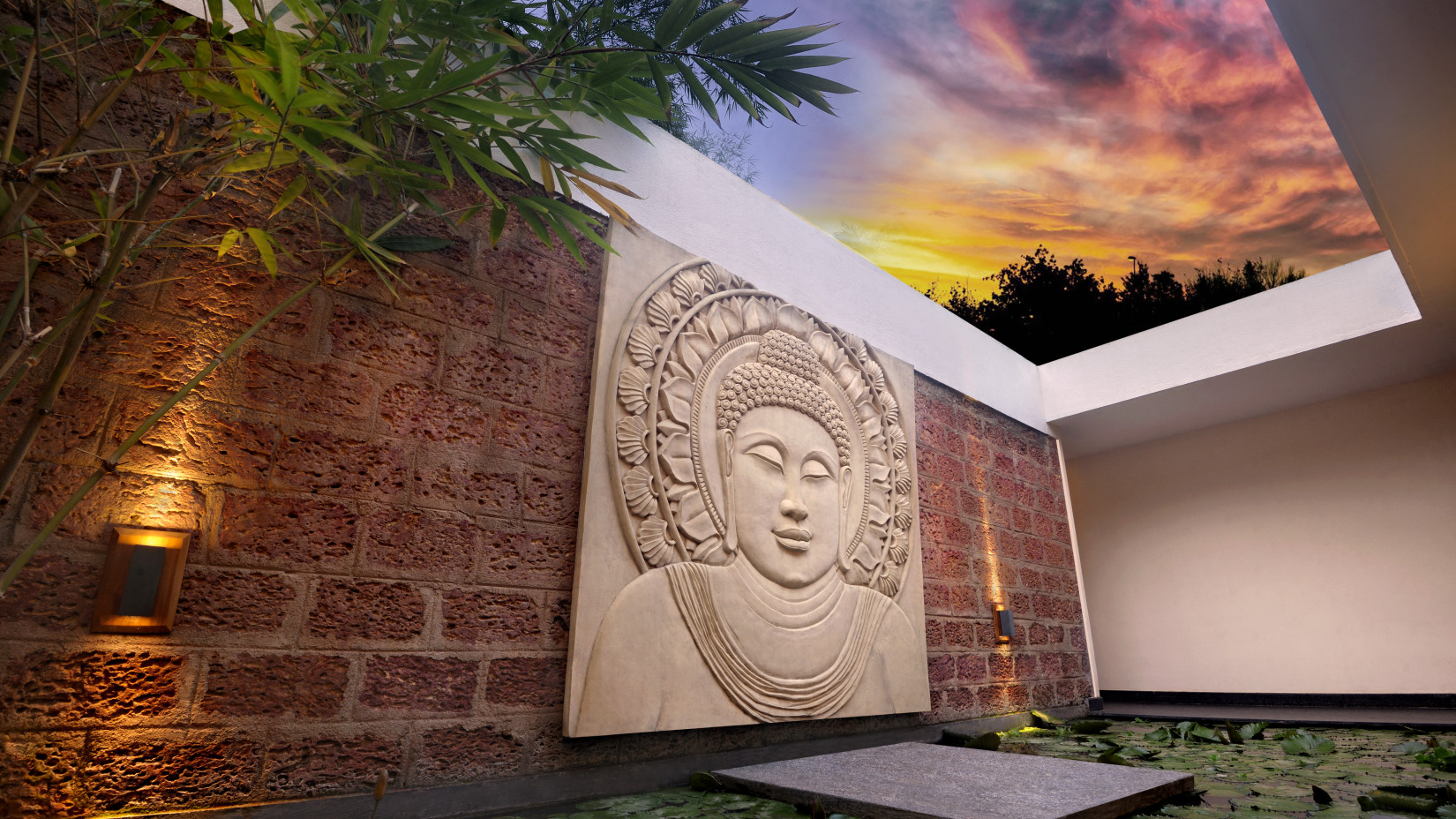 Artistic Buddha wall sculpture with ambient lighting in an outdoor setting.