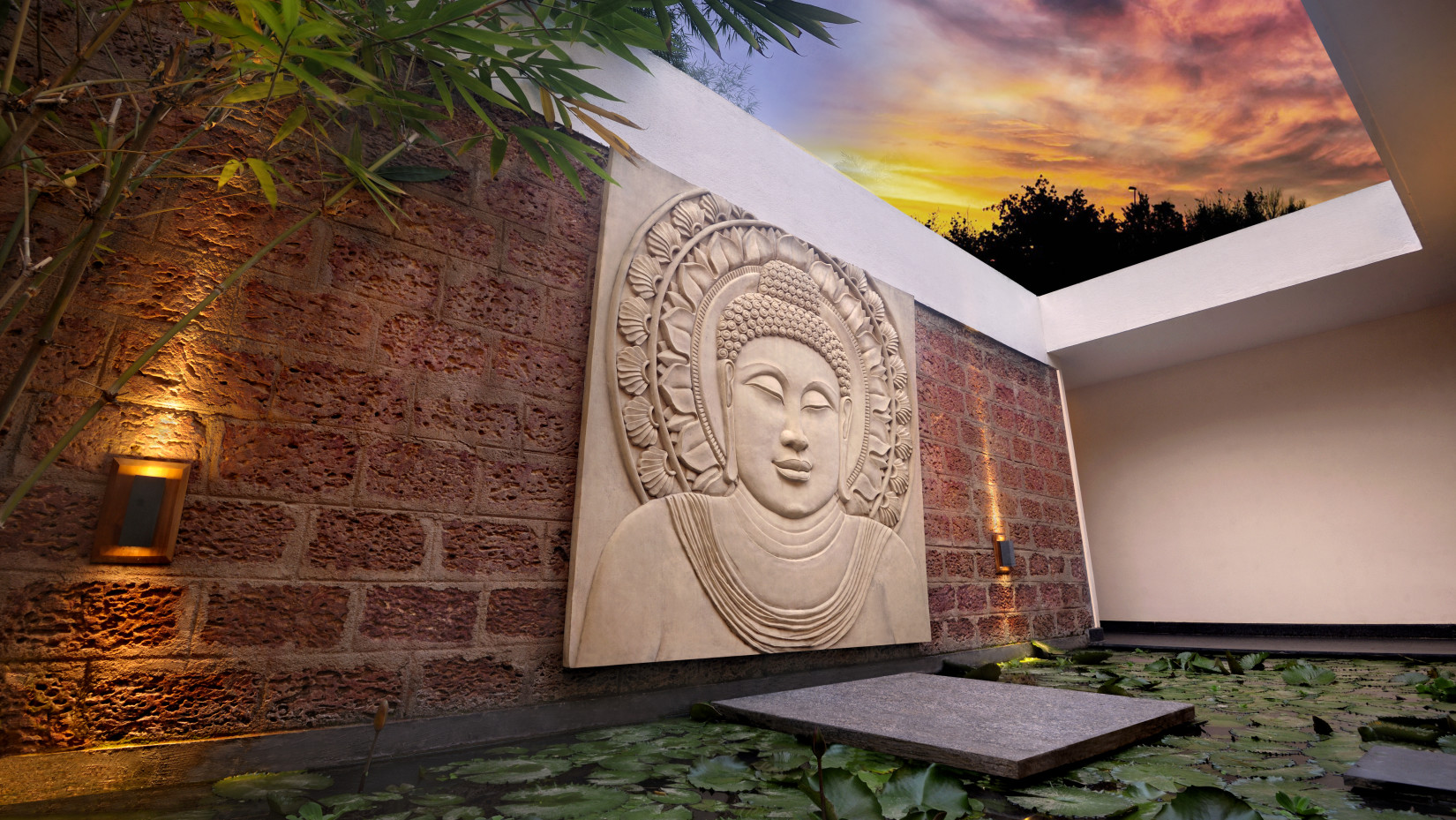 Artistic Buddha wall sculpture with ambient lighting in an outdoor setting.