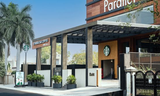 alt-text Entrance gate with wooden pillars at Parallel Hotel, Udaipur