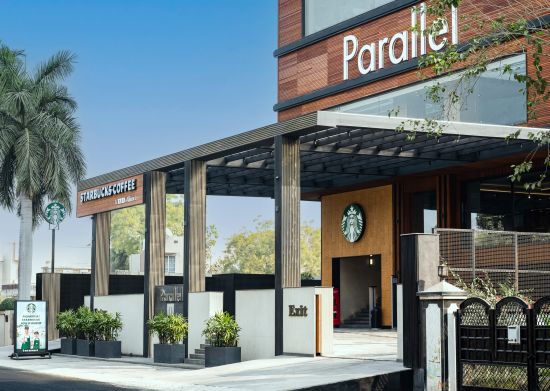 alt-text Entrance gate with wooden pillars at Parallel Hotel, Udaipur