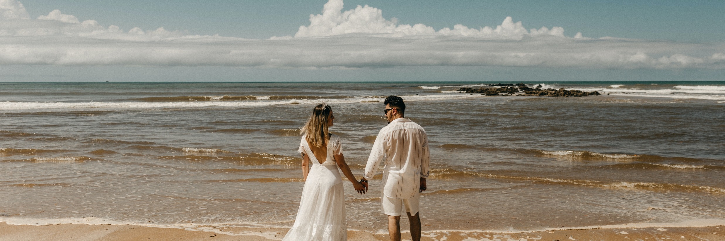 A couple walking towards the beach