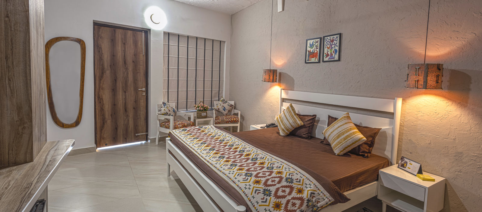 a warmly-lit interior of a valley view room at Kothli Hills, Rishikesh featuring a bed adorned with brown bedsheet and printed duvet