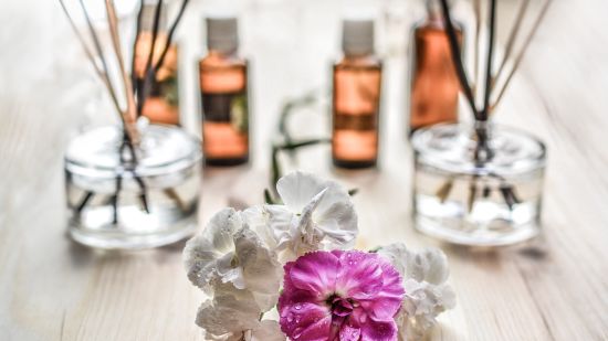 flowers and essential oils on table