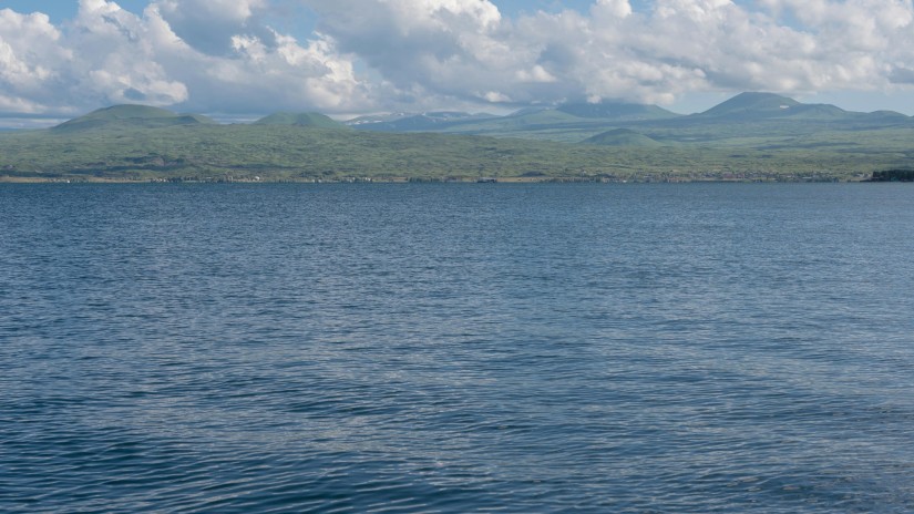 A serene view of a lake near a mountain