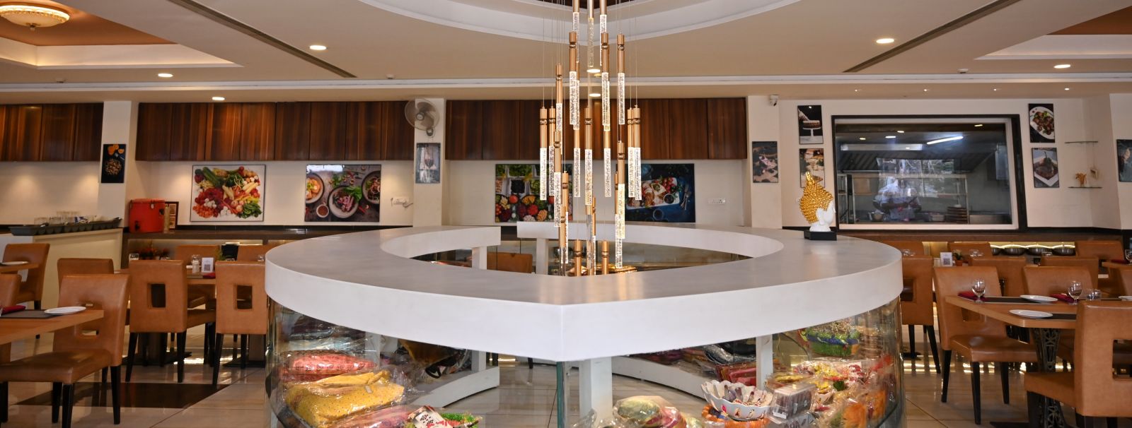 Hotel restaurant interior with circular centre piece display under a modern chandelier