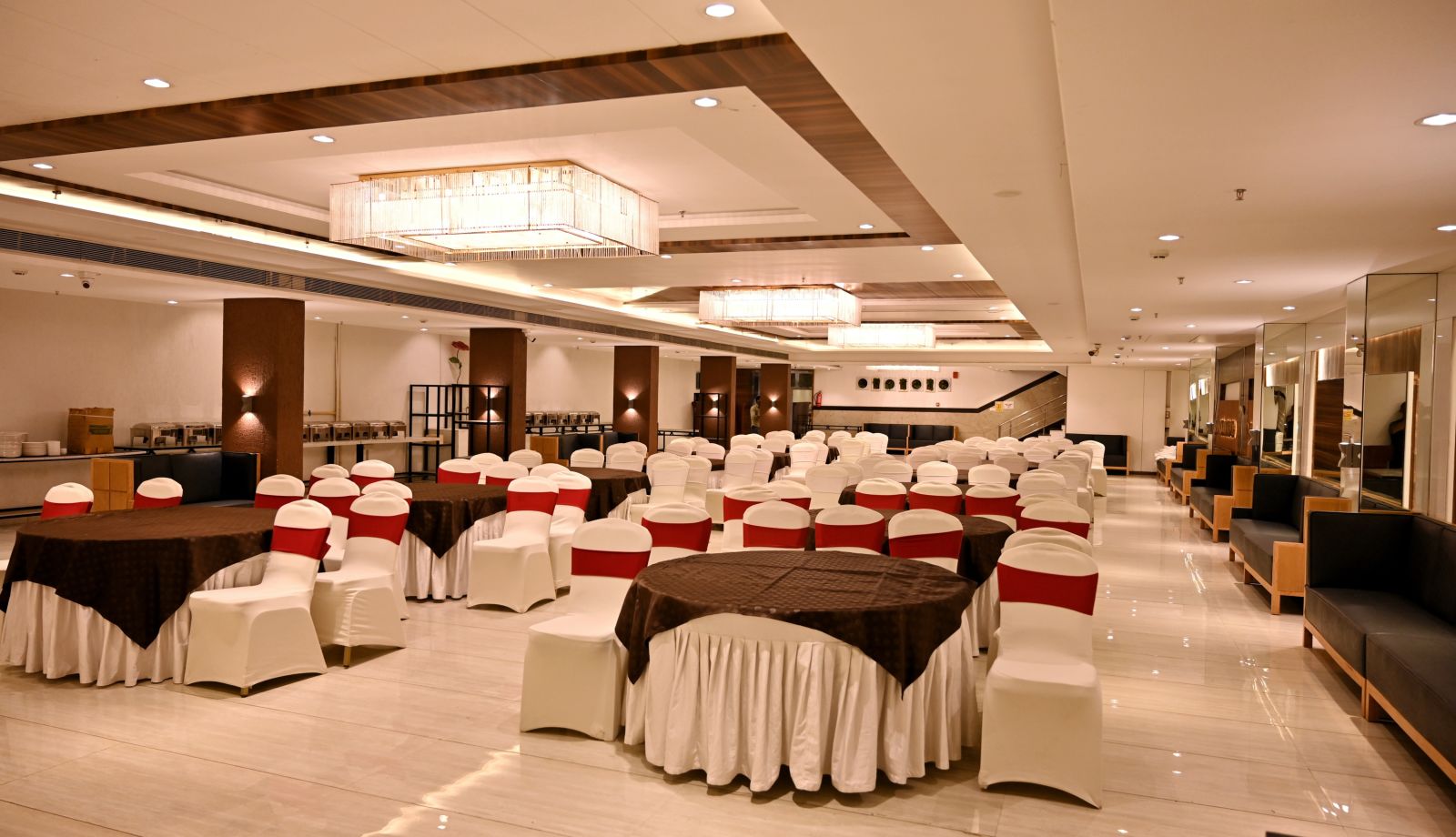 Banquet hall viewed from the end, showcasing the regal chandeliers and polished floors