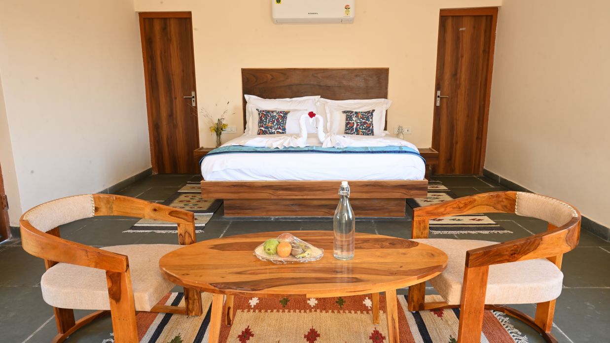 Clarks Safari Jawai - a view of the bedroom and the seating space offered by the cottage room with plunge pool in Jawai