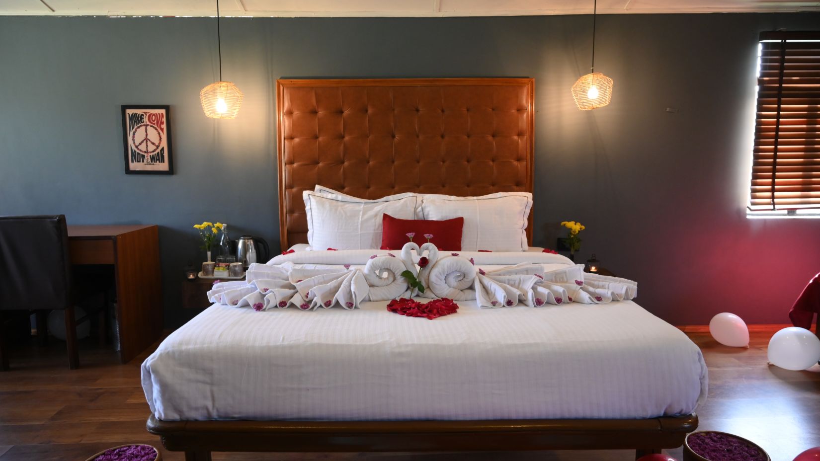 Romantically decorated hotel room with a large bed and rose petals