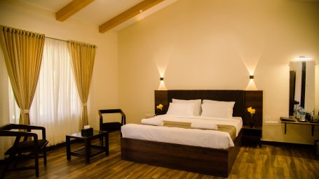 Morpho Banashree Resort - interior view of bedroom with coffee table and bed