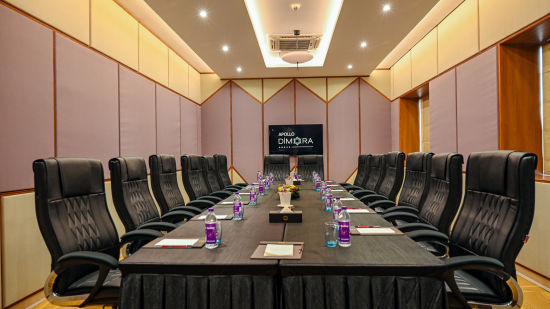 black coloured seats and a large table offered at the boardroom 