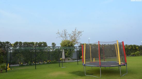 Trampoline in lawn - Themis Farm House, Panipat