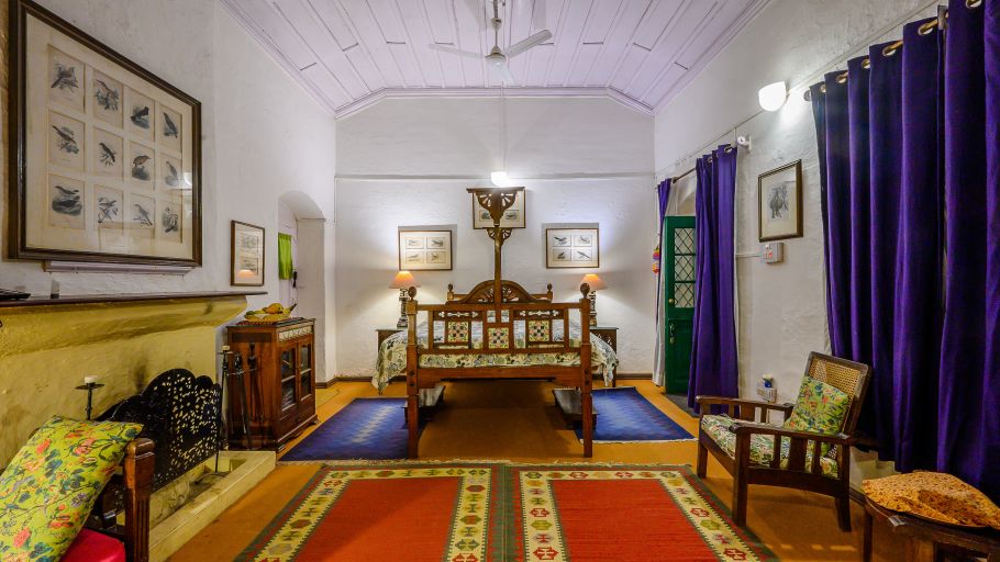 The Ramgarh Bungalows - royal Bird room full view with luxurious blue decor and a queen size bed