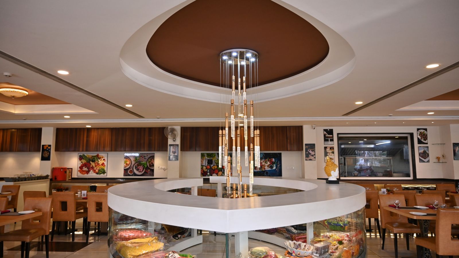 Hotel restaurant interior with circular centre piece display under a modern chandelier