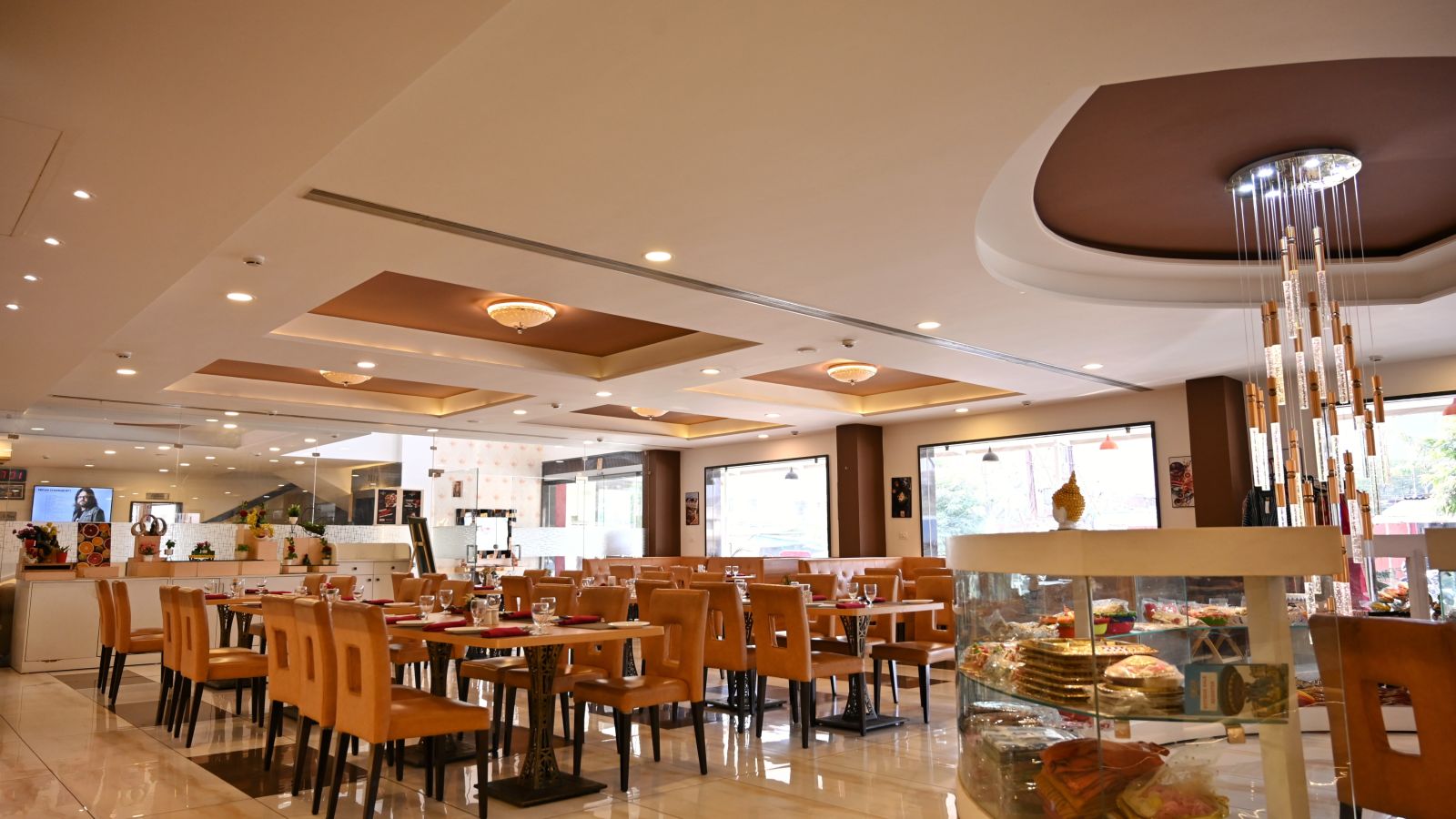 Hotel dining area with neatly arranged tables, contemporary art and a service counter