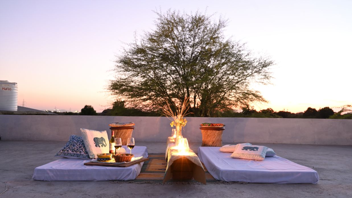 Clarks Safari Jawai - the rooftop seating arrangement with a bonfire between two mattresses