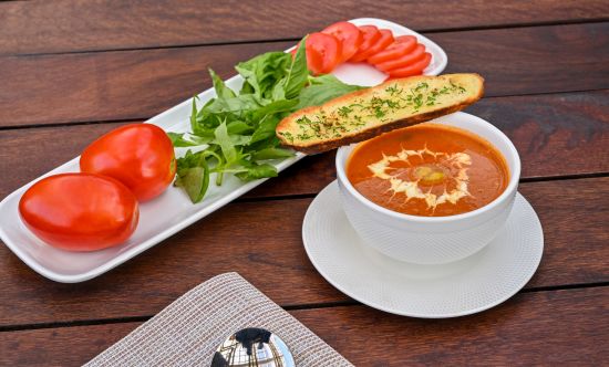 alt-text Breadstick on a bowl of soup and sides at Parallel Hotel, Udaipur