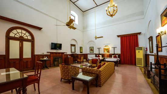 An overview of the Raja Amar Singh room with sofas, coffee table in front of the tv - The Baradari palace