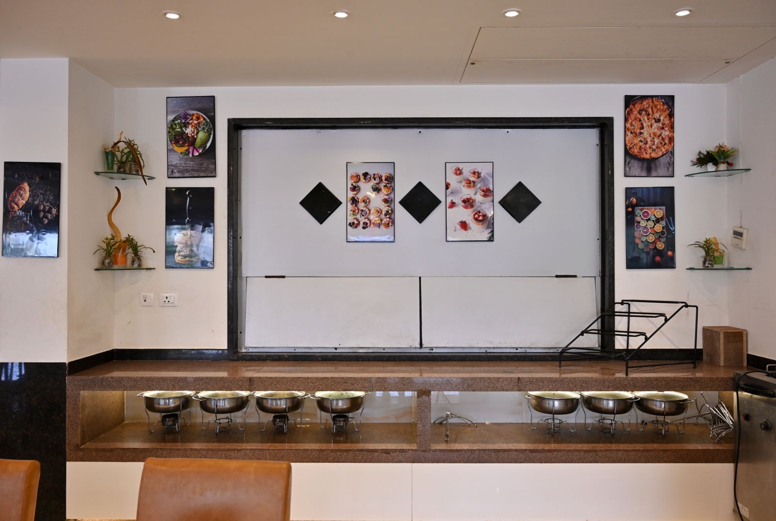 Buffet serving area with warming trays in a hotel restaurant