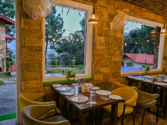 a dining area featuring tables and chairs - The Nature's Green Resort, Bhimtal