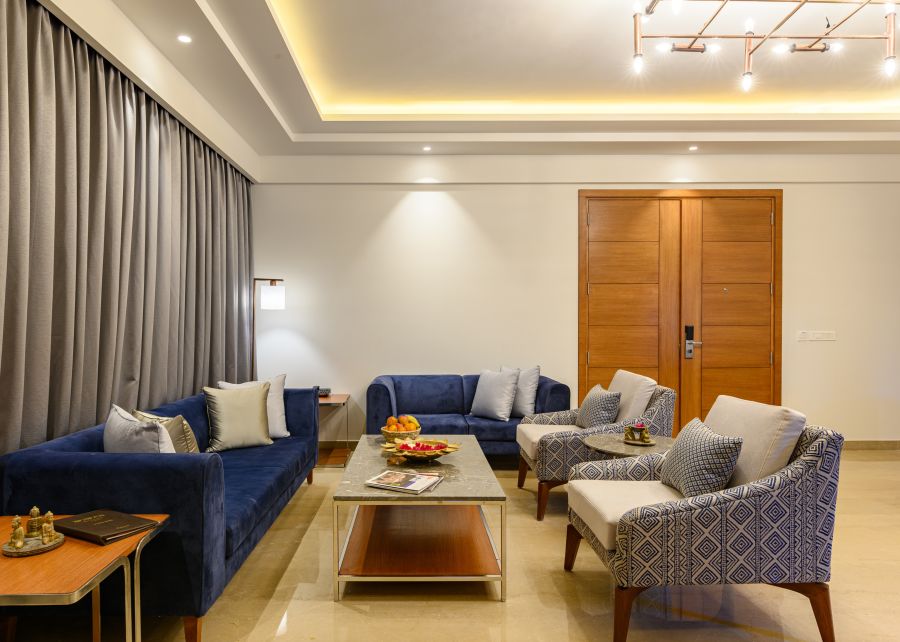 alt-text The living room of our Presidential Suites in Pushkar with  a sofa set, a television and a large window PS-4243