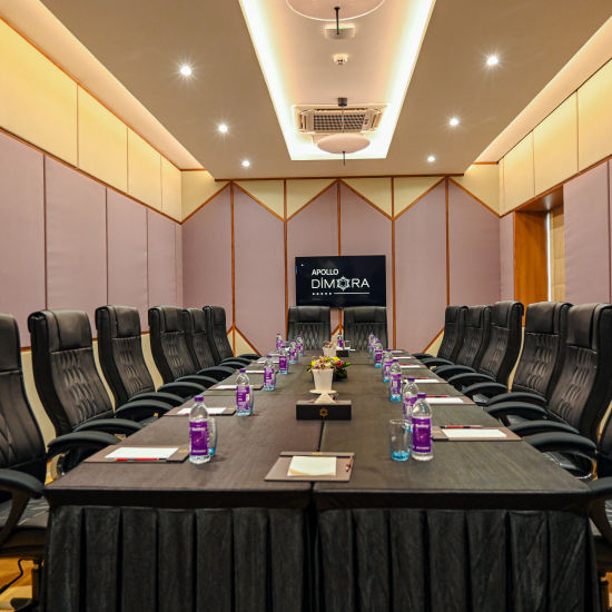 black coloured seats and a large table offered at the boardroom 