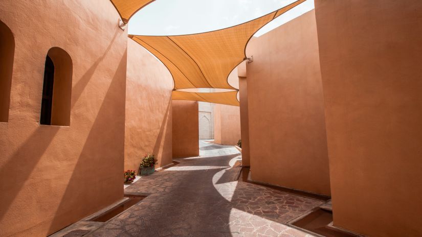 An overview of the streets of Katara Cultural Village with sun shade on the roof