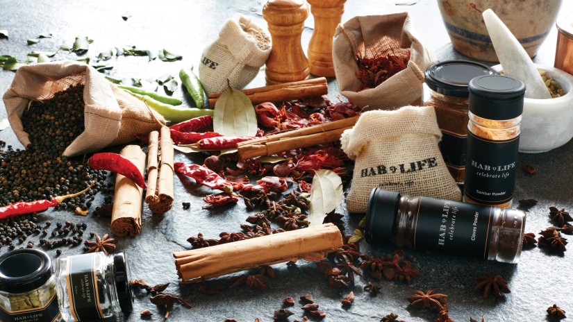 Jars of food items and spices on a table at Hablis Hotel, Chennai