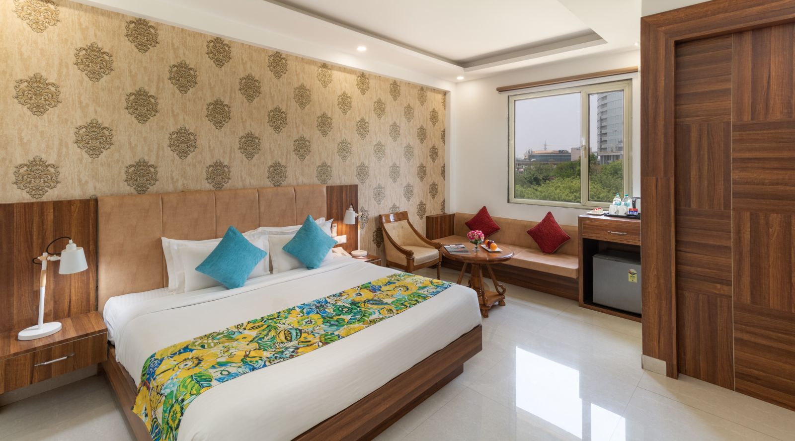 A spacious hotel room featuring a king size bed, comfortable seating, and modern amenities | Inde Hotel Cyber City 