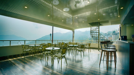 full view of Sky bar lounge captured during the day showcasing the kanchenjunga hills - the aryan regency