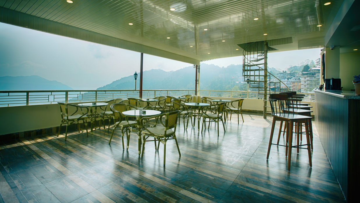 full view of Sky bar lounge captured during the day showcasing the kanchenjunga hills - the aryan regency