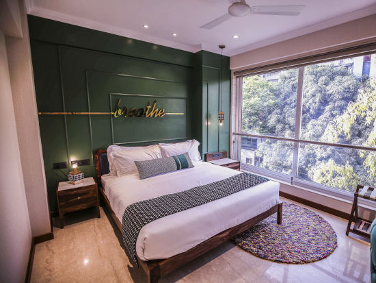 bedroom with modern interior and expansive window overlooking the city