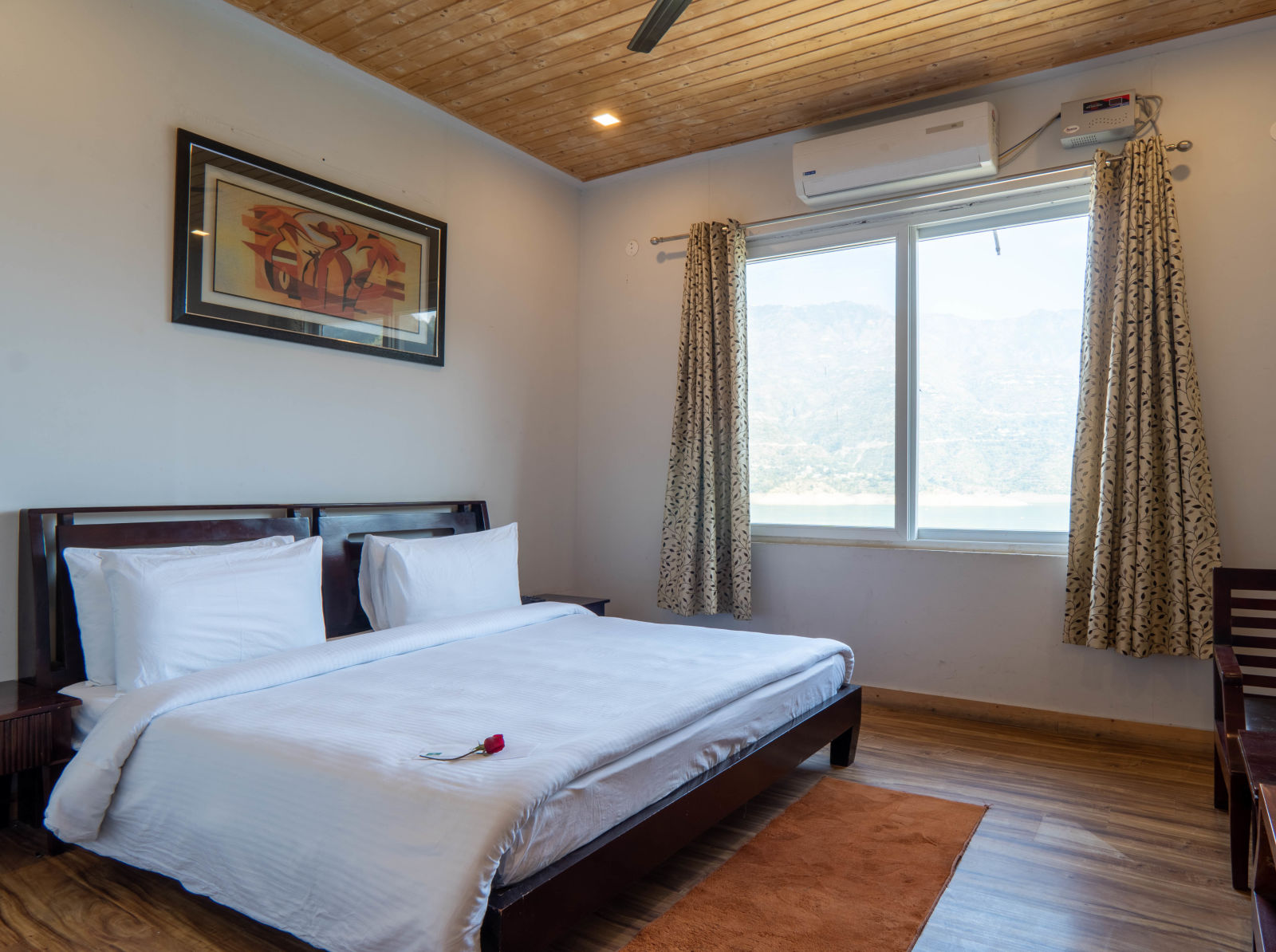 floating huts - over the lake bedroom with a posh bed placed next to the window with lake view - Le ROI Floating Huts Eco Rooms