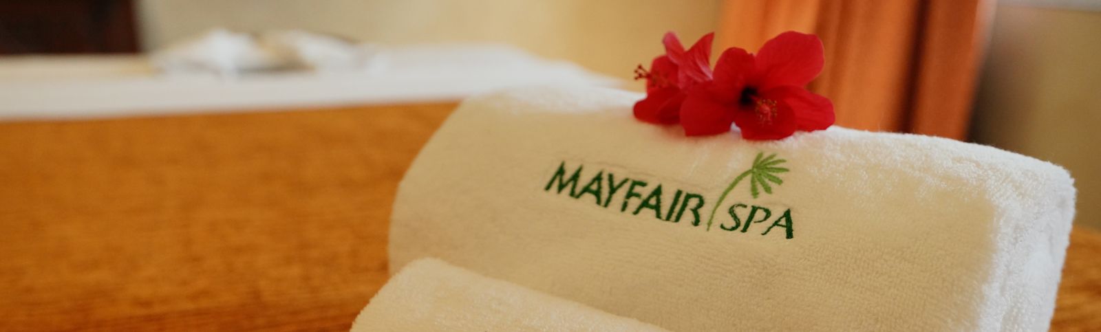 two folded towels with the name mayfair spa printed on them - Mayfair Tea Resort, Siliguri 