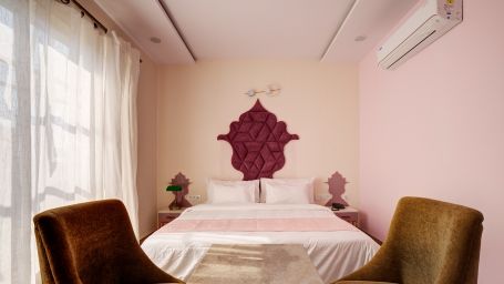 Pink themed Super Deluxe Room with chairs - The White Moon