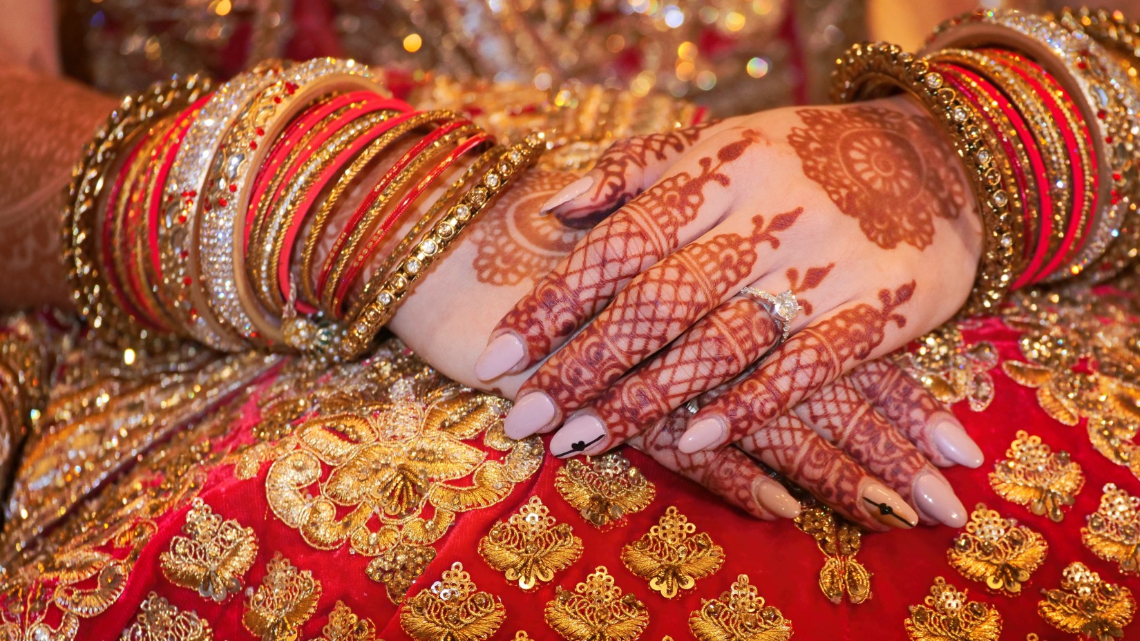 a close up image of a Mehendi on a bride's hands - Hablis Hotel, Chennai