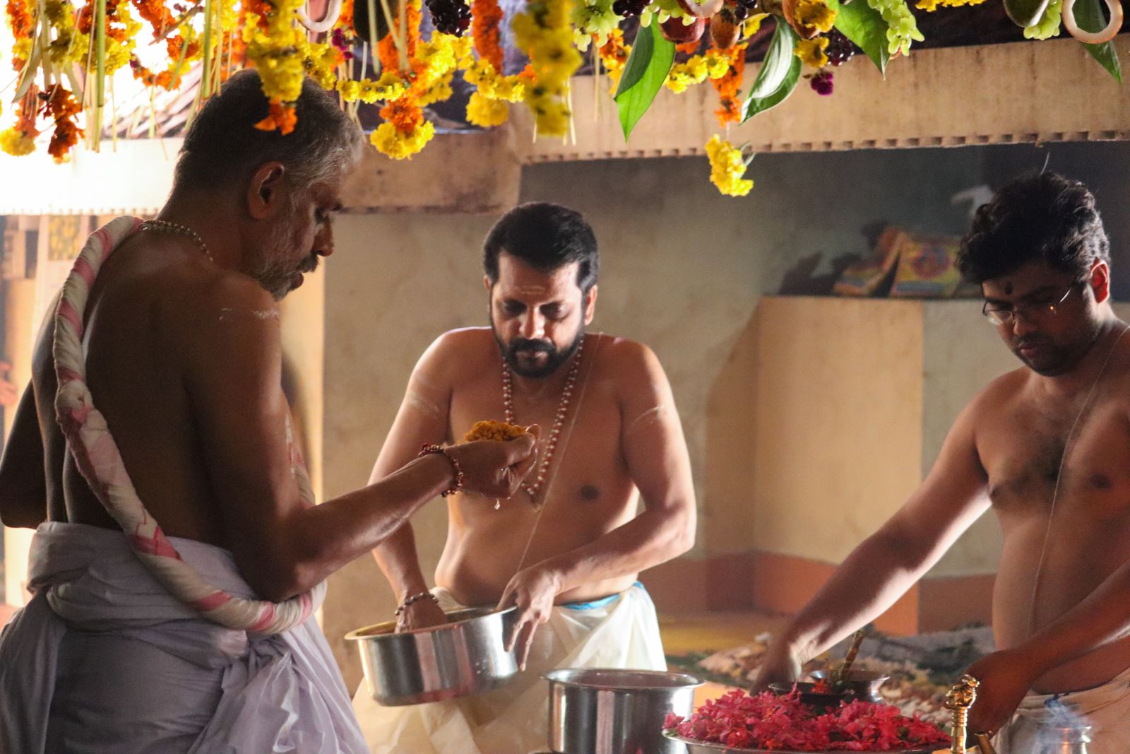 priests preparing prasad at a temple