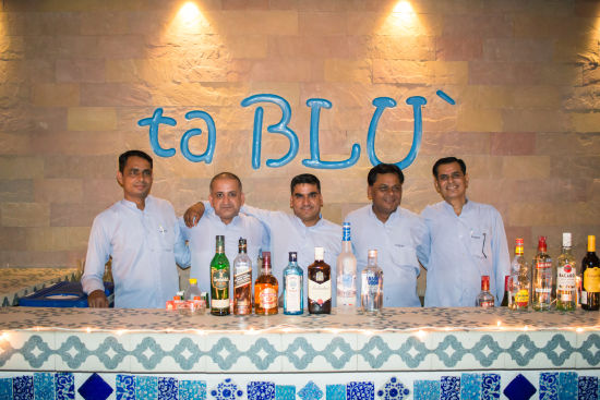 alt-text The chefs and the culinary staff members pose for a photograph at ta Blu