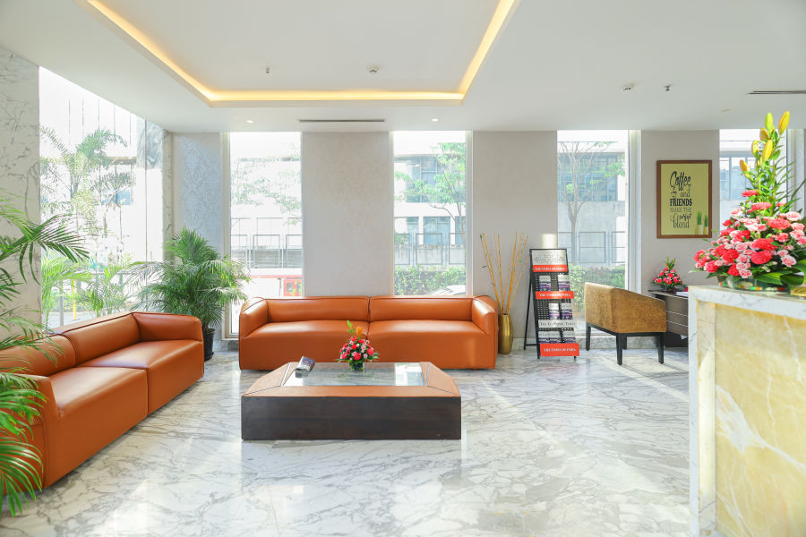 alt-text Lobby corridor with a spacious, cozy sofa in the corner at Icon Premier Hotel by Bhagini, Devarabisanahalli