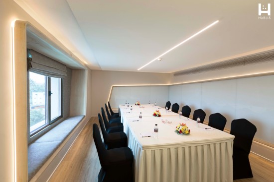 alt-text Seating arrangement at a boardroom at Hablis Hotel, Chennai 