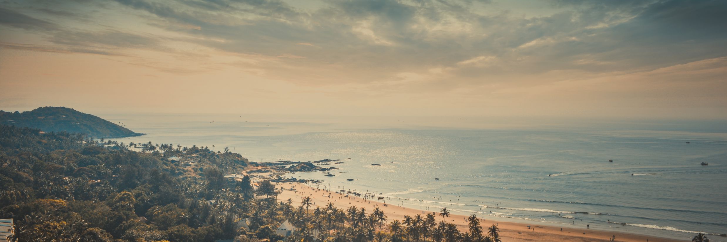 goa beach with mountain in sight and blue sky and water @ Lamrin Ucassaim Hotel, Goa