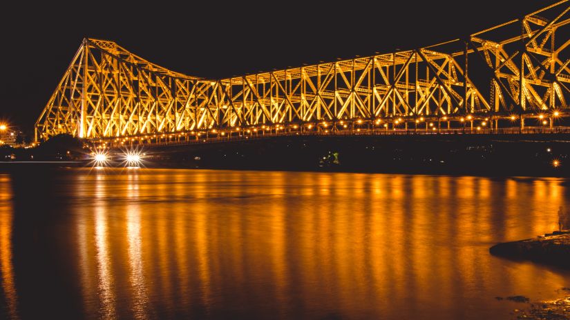 howrah bridge in the night with lights on 